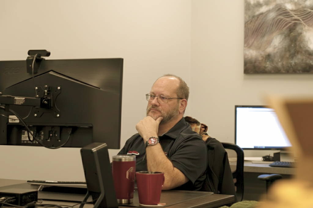 an OnTrack IT team member displaying a focused and thoughtful approach to a project at his desk
