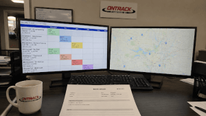 Commercial HVAC dispatcher workstation showing scheduling software and field technician route map used to manage daily service operations.