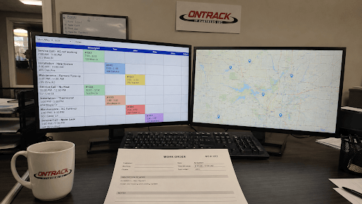 Commercial HVAC dispatcher workstation showing scheduling software and field technician route map used to manage daily service operations.